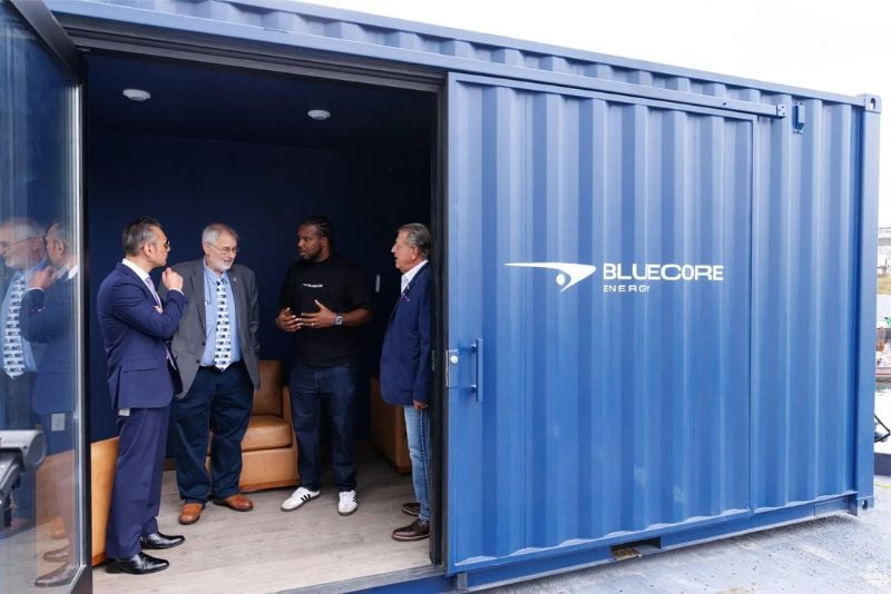 Bluecore founder Kofi Asante (center right) with guests inside a converted shipping container