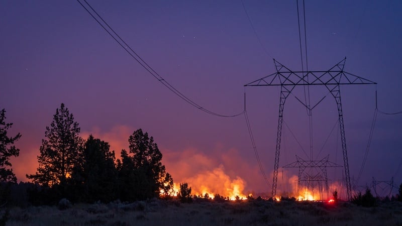 Figure 2. A California wildfire burns under power lines.