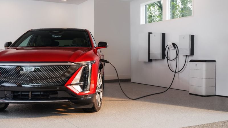 GM Energy’s home storage system connects to a Cadillac EV in a garage