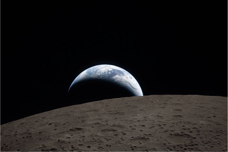 The moon’s surface with Earth on the horizon, taken from Artemis II.